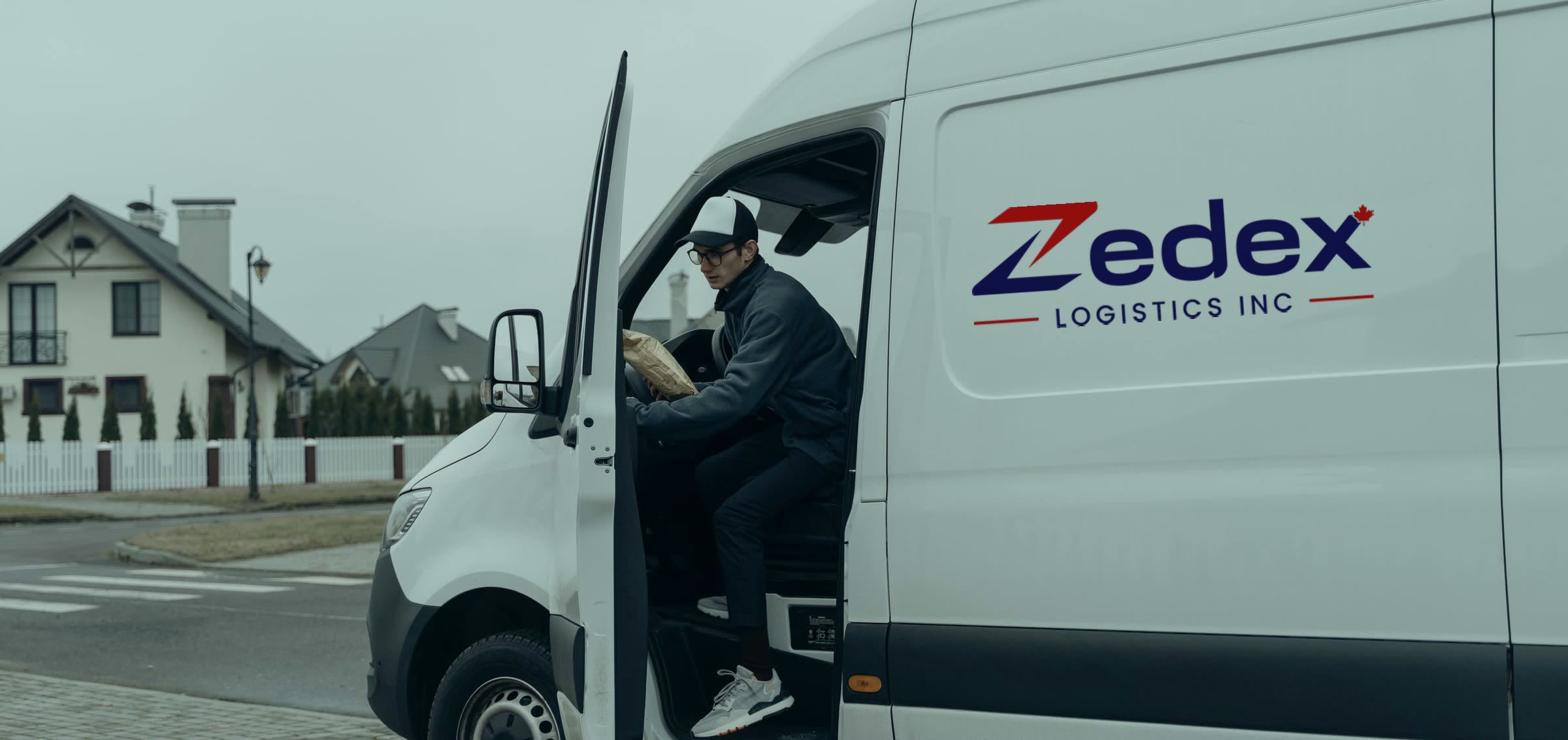 A Zedex courier stepping out of a branded van on a residential street